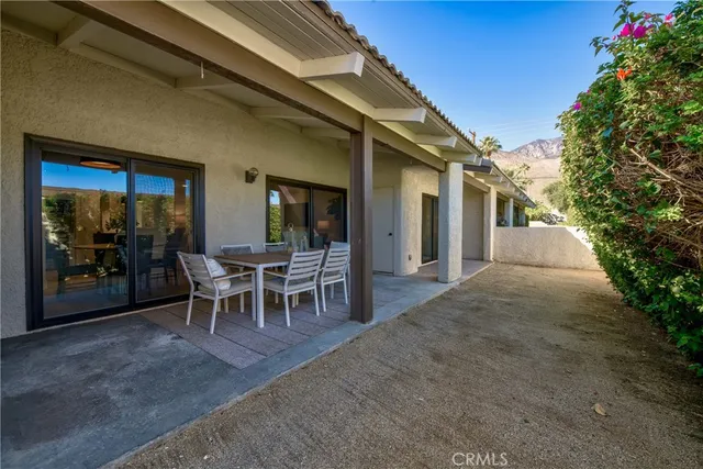 a view of a backyard with a patio and outdoor seating
