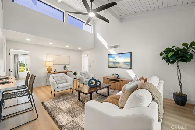 a living room with furniture and a potted plant