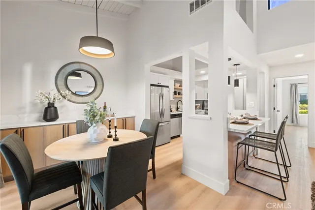 a view of a dining room with furniture and a chandelier