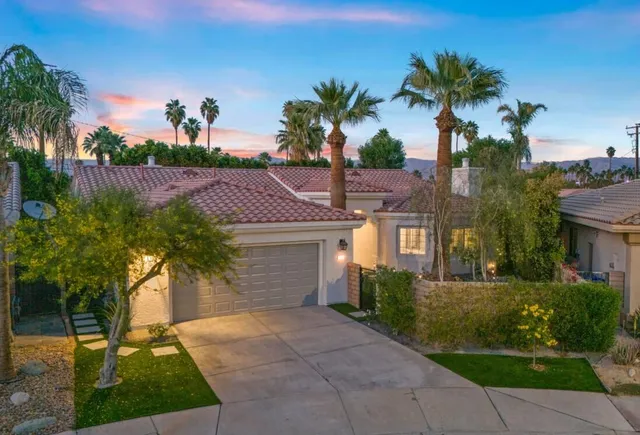 a aerial view of a house with lots of plants and flowers