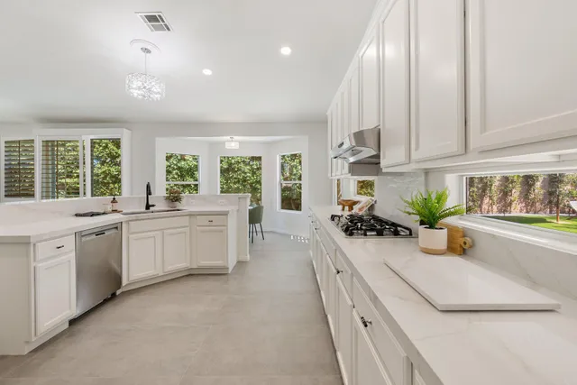 a view of a dining room with furniture and chandelier