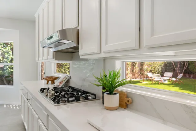a living room with furniture fireplace and a window