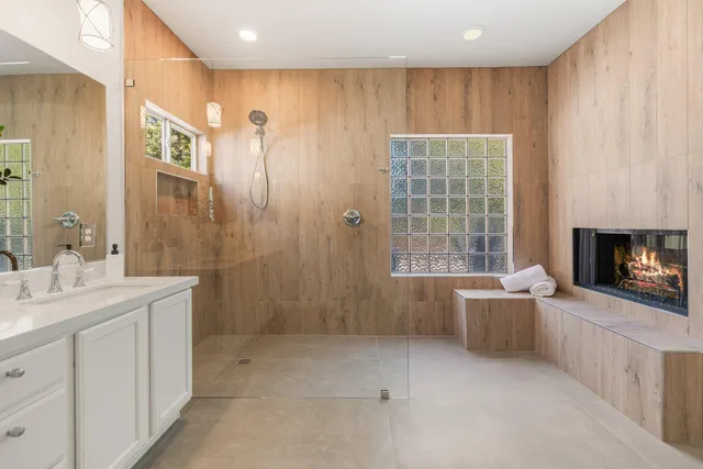 a bathroom with a granite countertop sink a toilet and shower