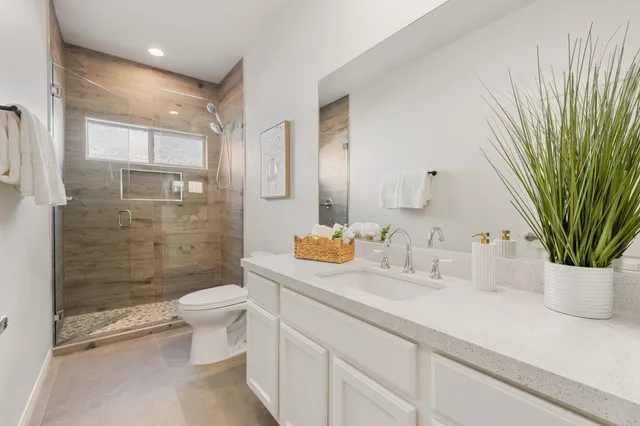 a view of a chair and table in backyard of the house