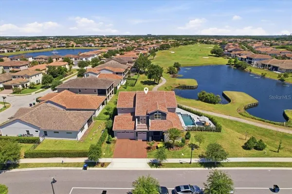 an aerial view of a house with a lake view