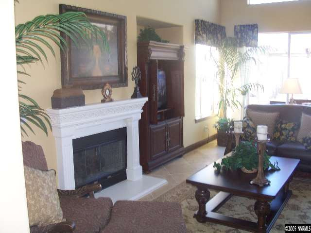 14065 Winners Cup Drive Reno, NV 89521 - Photo 4 of 9 a living room with furniture and a fireplace