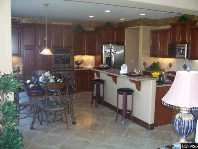 14065 Winners Cup Drive Reno, NV 89521 - Photo 5 of 9 a kitchen with kitchen island granite countertop furniture a sink a counter and appliances
