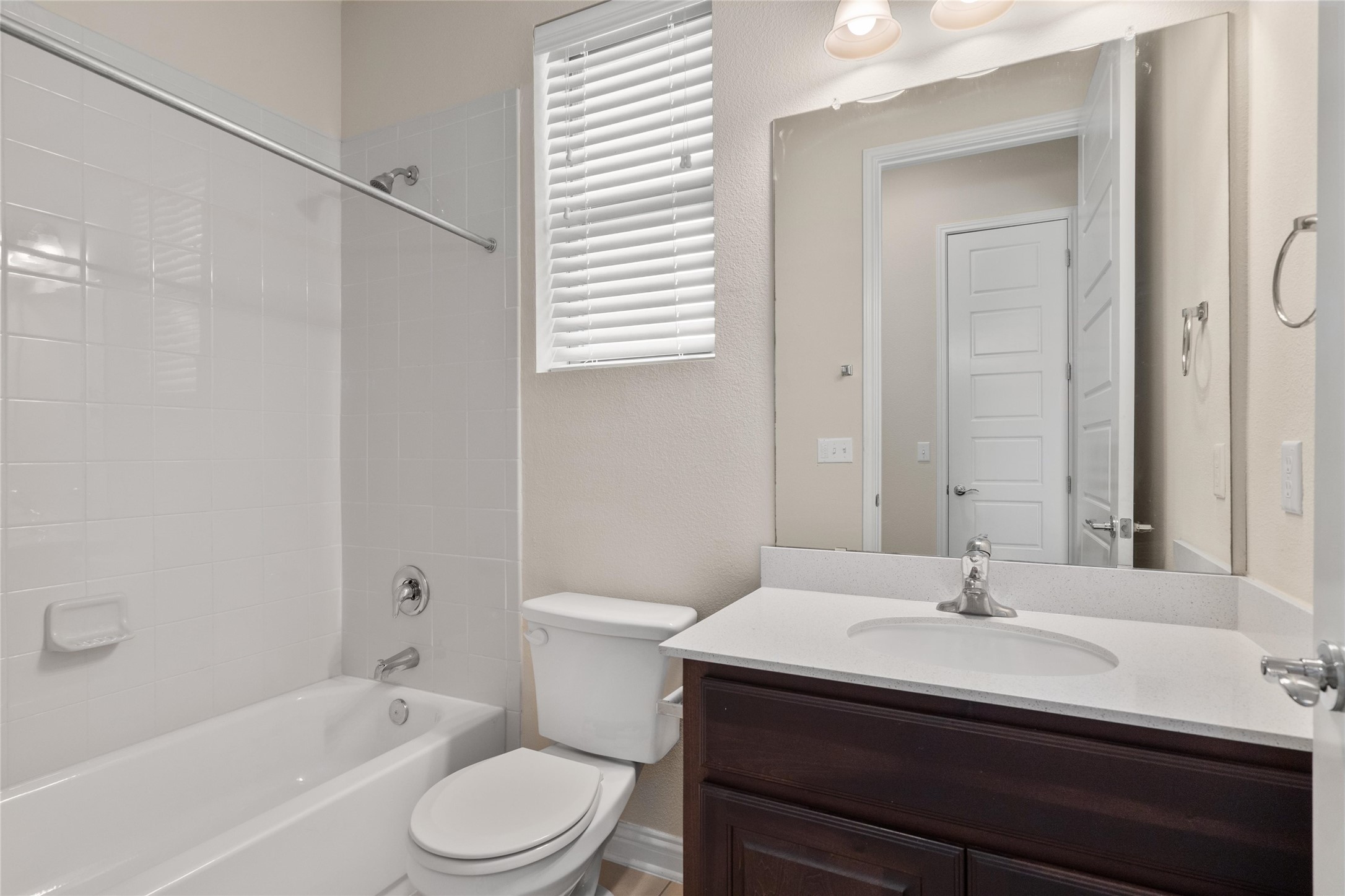 6907 Idea Road Austin, TX 78741 - Photo 16 of 36 a bathroom with a sink toilet a mirror and shower