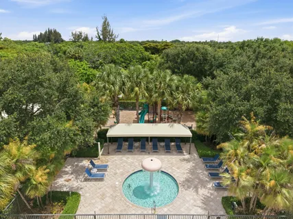 an aerial view of residential houses with outdoor space and swimming pool