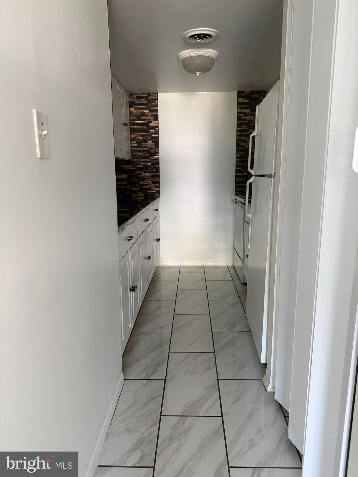 608 Easton Road Willow Grove, PA 19090 - Photo 8 of 16 Modern kitchen corridor with sleek tiles.