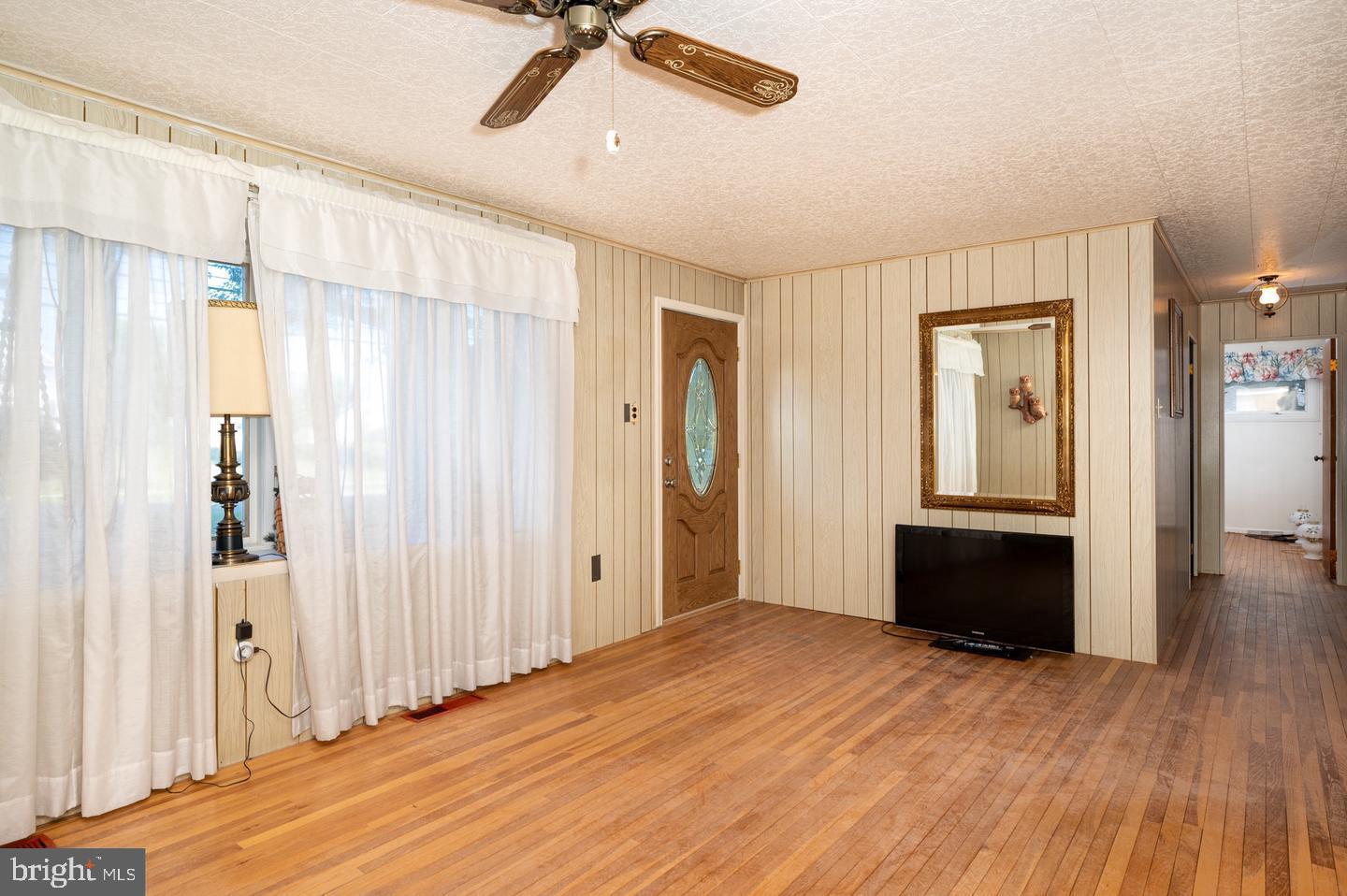 691 North Lewis Road Royersford, PA 19468 - Photo 4 of 21 a view of an empty room with window and wooden floor