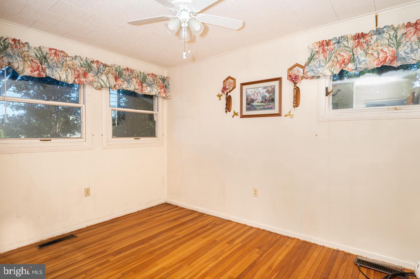 691 North Lewis Road Royersford, PA 19468 - Photo 10 of 21 a view of a livingroom with wooden floor and a ceiling fan