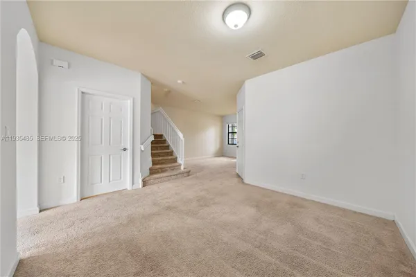 a view of an empty room with stairs