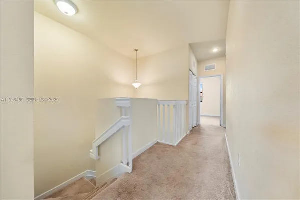 a view of a hallway with staircase