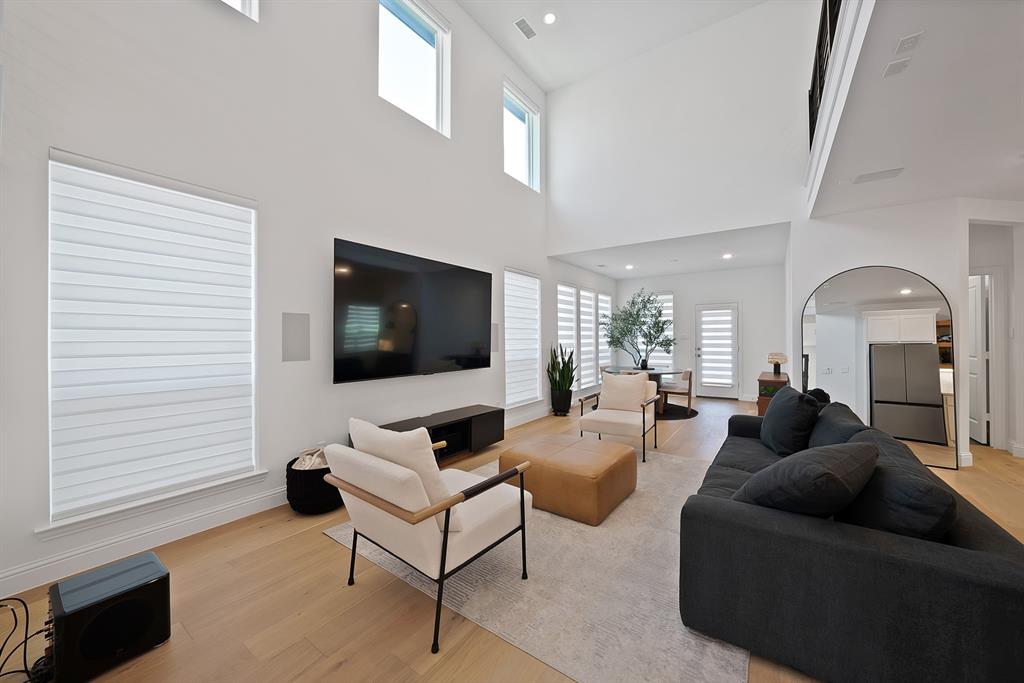 5012 Triadic Lane Prosper, TX 75078 - Photo 12 of 38 Soaring two-story ceiling and abundant natural light highlight this spacious living area