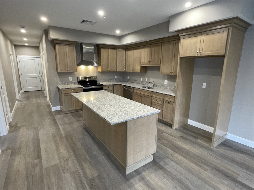 1 Brattle Street, Unit 3 Worcester, MA 01606 - Photo 15 of 21 a kitchen with stainless steel appliances granite countertop a stove and a refrigerator