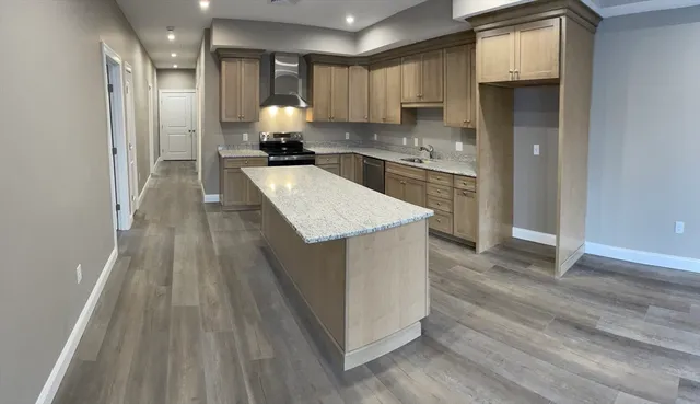 a kitchen with a sink stainless steel appliances and cabinets