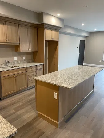a kitchen with stainless steel appliances granite countertop a stove a sink and a refrigerator
