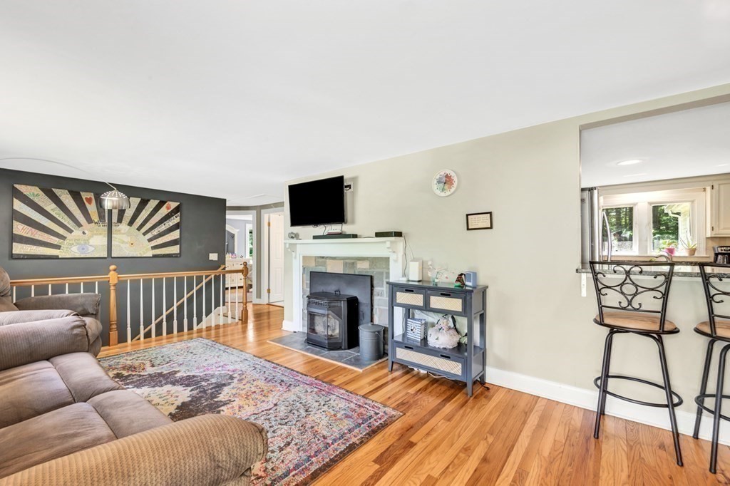 49 Woodland Road Ashland, MA 01721 - Photo 11 of 36 a living room with furniture and a fireplace