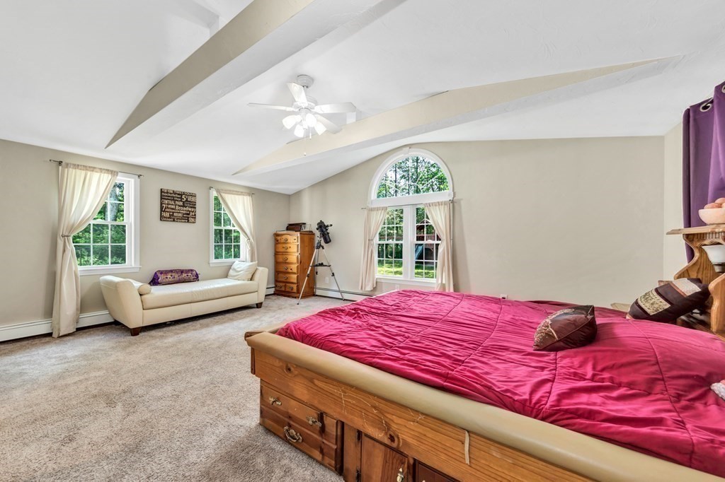 49 Woodland Road Ashland, MA 01721 - Photo 18 of 36 a bedroom with a bed and a large window