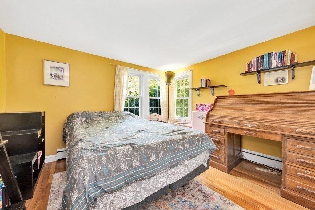 49 Woodland Road Ashland, MA 01721 - Photo 23 of 36 a bed sitting in a bedroom next to a window