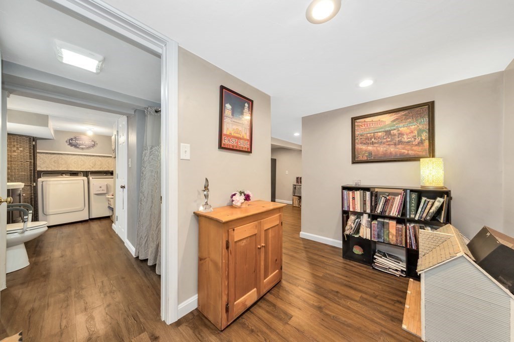 49 Woodland Road Ashland, MA 01721 - Photo 26 of 36 a view of a hallway with workspace and wooden floor