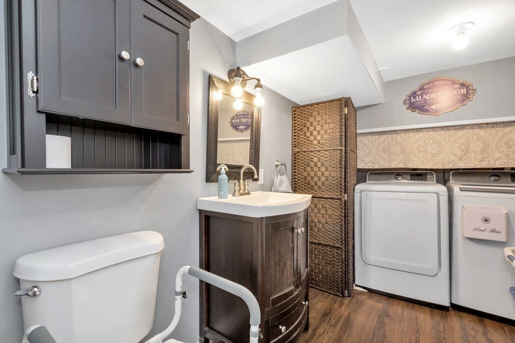 49 Woodland Road Ashland, MA 01721 - Photo 27 of 36 a bathroom with a sink toilet and mirror