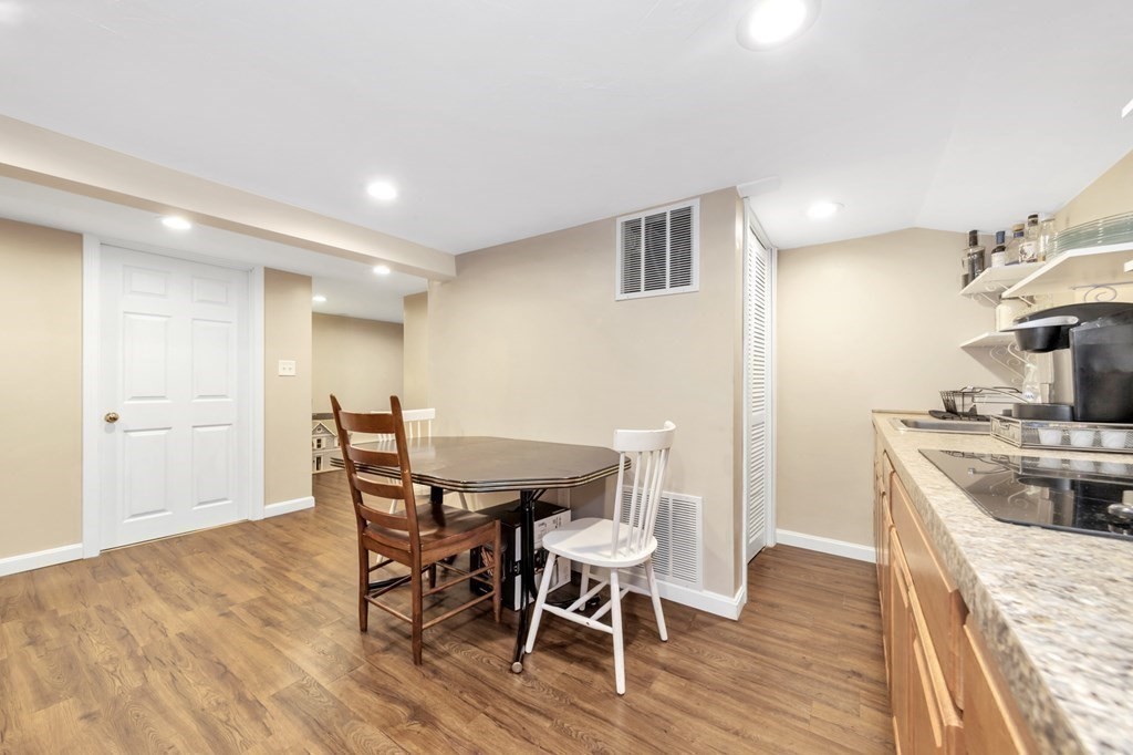 49 Woodland Road Ashland, MA 01721 - Photo 28 of 36 a kitchen with a table and chairs in it