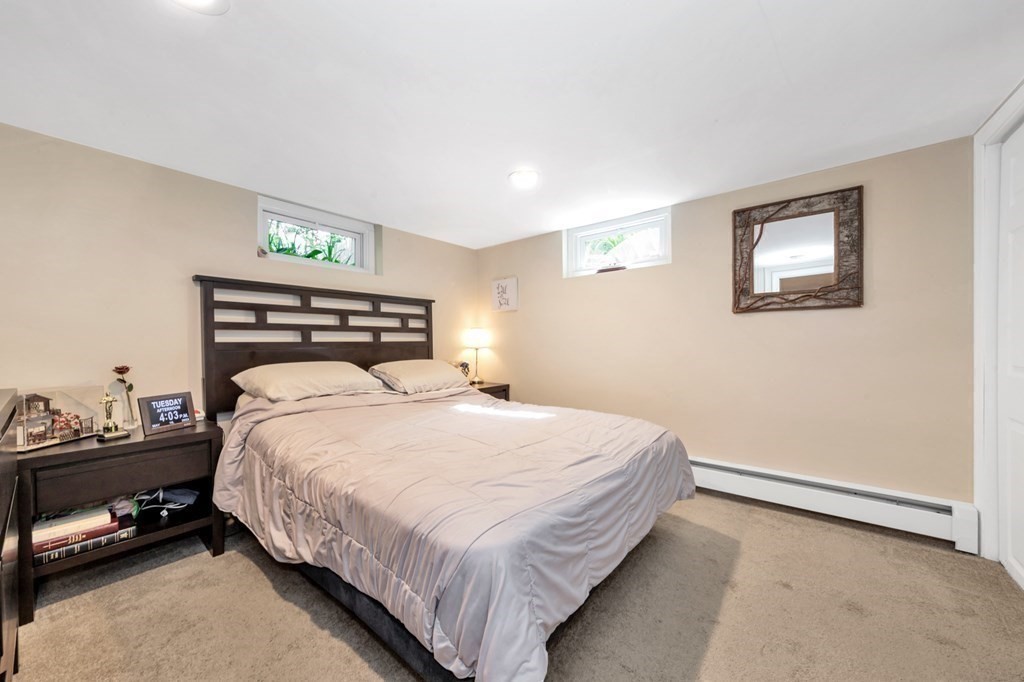 49 Woodland Road Ashland, MA 01721 - Photo 30 of 36 a bedroom with a bed and a night stand