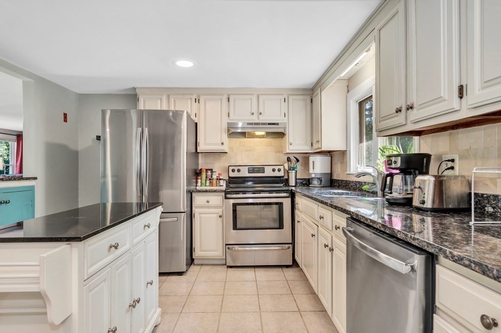 49 Woodland Road Ashland, MA 01721 - Photo 3 of 36 a kitchen with stainless steel appliances granite countertop a refrigerator and a stove