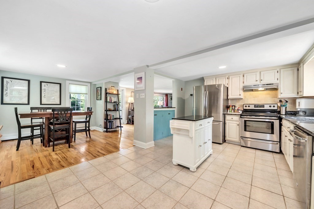 49 Woodland Road Ashland, MA 01721 - Photo 6 of 36 a kitchen with white cabinets and appliances