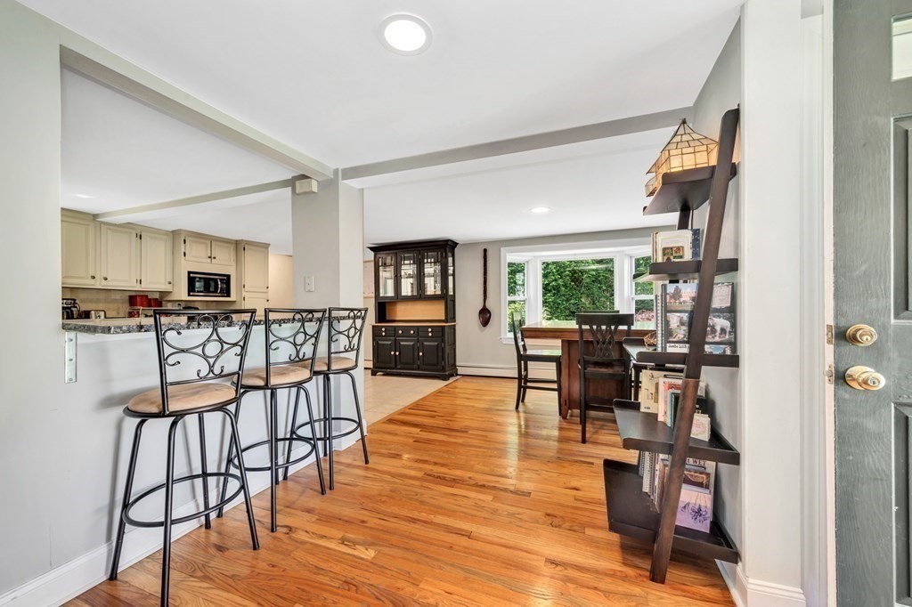 49 Woodland Road Ashland, MA 01721 - Photo 8 of 36 a view of a dining room with furniture window and wooden floor