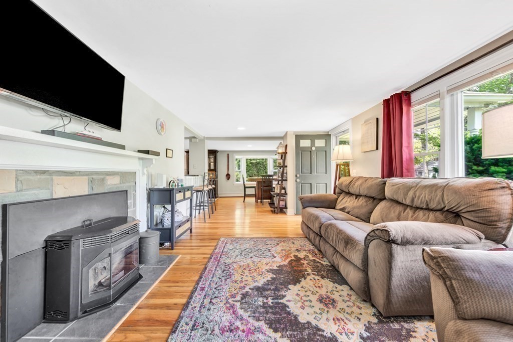49 Woodland Road Ashland, MA 01721 - Photo 9 of 36 a living room with furniture and a flat screen tv
