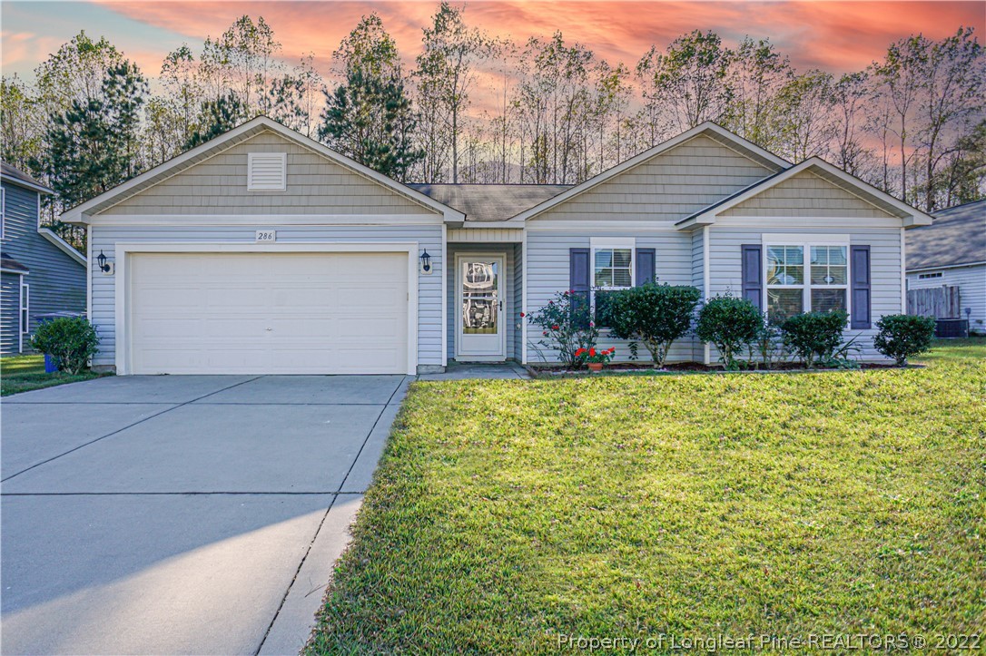 286 Cape Fear Road Raeford, NC 28376 - Photo 1 of 46 a front view of a house with garden