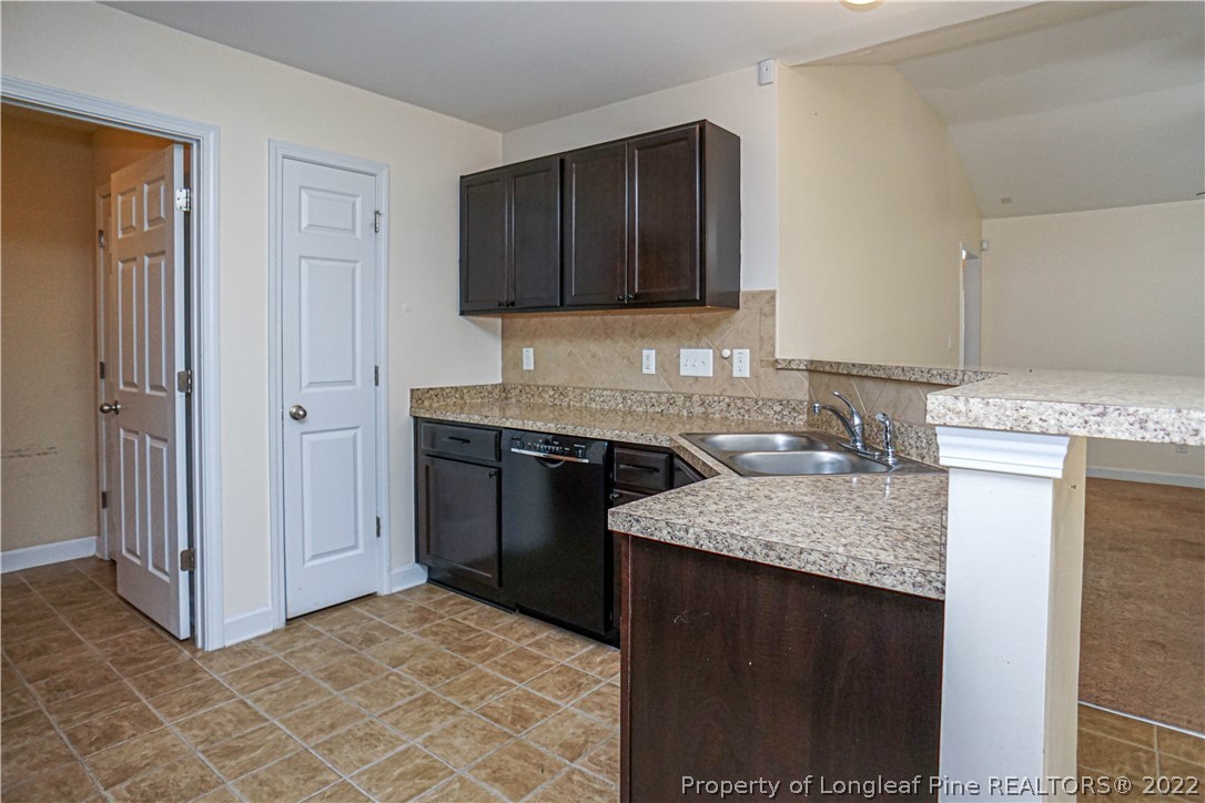 286 Cape Fear Road Raeford, NC 28376 - Photo 12 of 46 a kitchen with a granite countertop sink and a stove