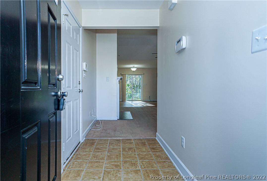 286 Cape Fear Road Raeford, NC 28376 - Photo 2 of 46 a view of a hallway with wooden floor and a bathroom