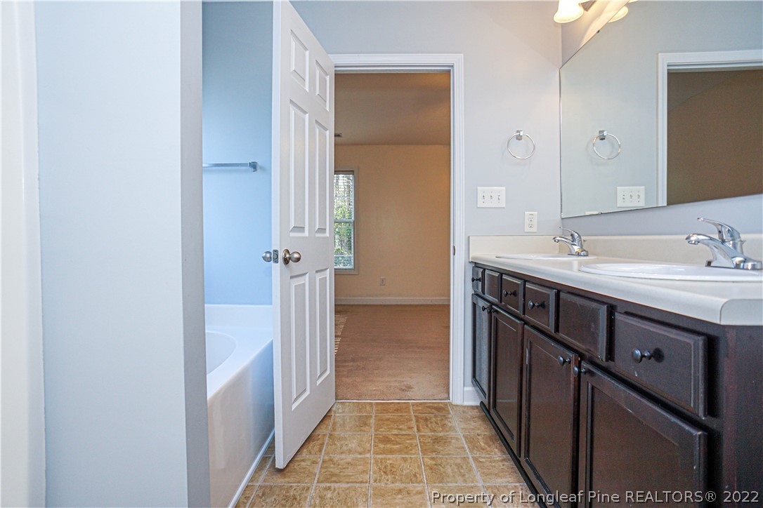 286 Cape Fear Road Raeford, NC 28376 - Photo 23 of 46 a bathroom with a sink a toilet and shower