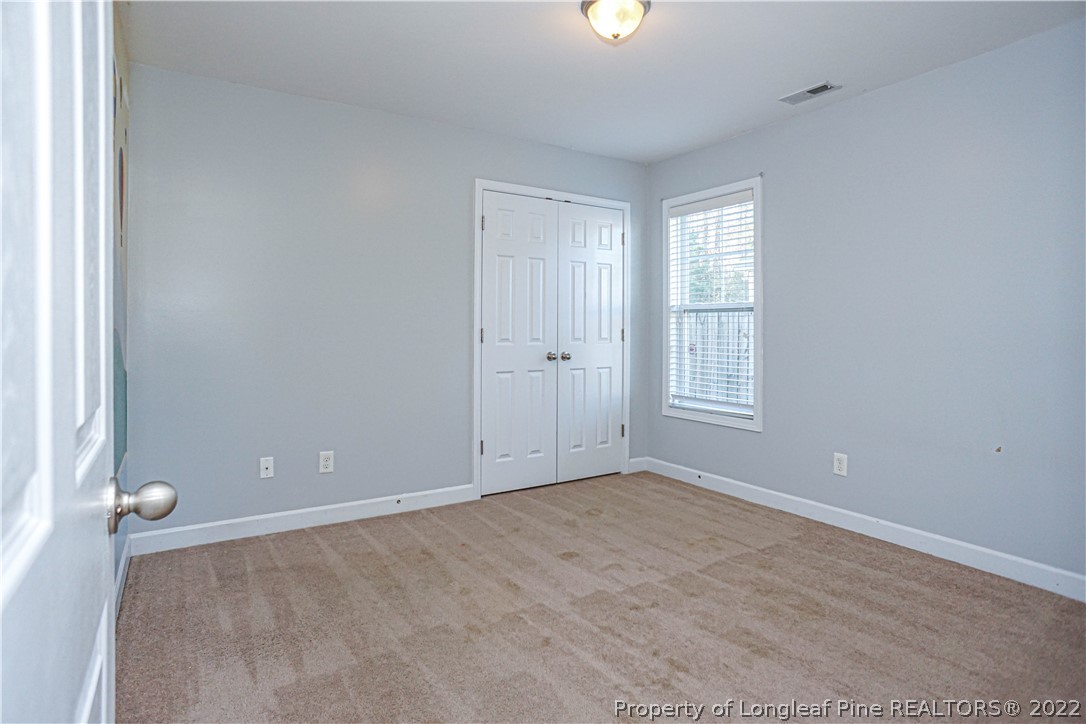 286 Cape Fear Road Raeford, NC 28376 - Photo 32 of 46 an empty room with windows and closet