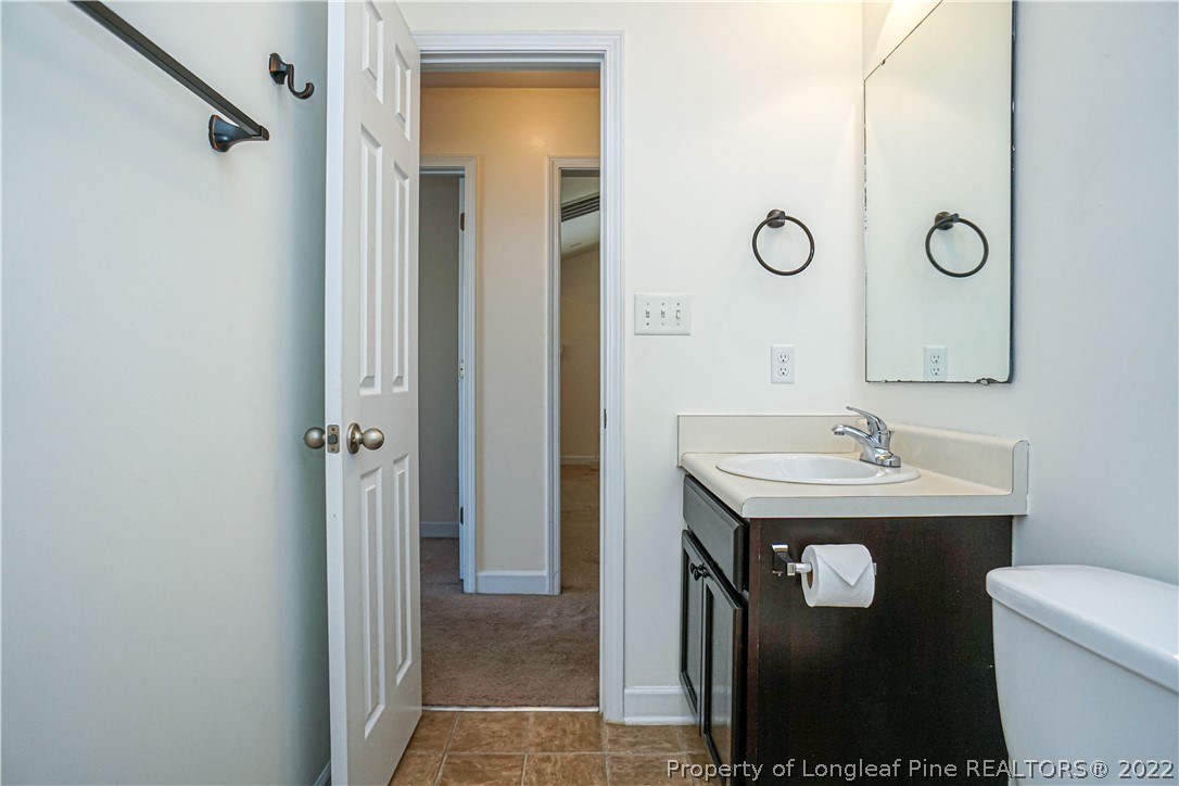286 Cape Fear Road Raeford, NC 28376 - Photo 34 of 46 a bathroom with a sink a toilet and a mirror