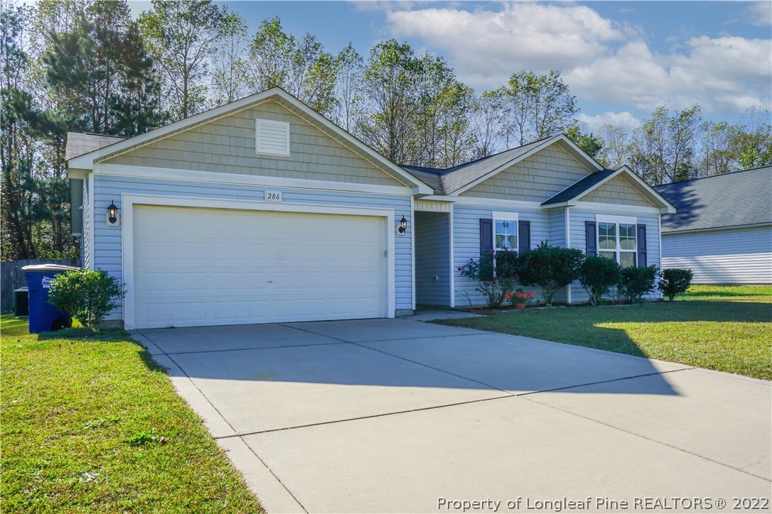 286 Cape Fear Road Raeford, NC 28376 - Photo 41 of 46 a front view of a house with a yard and garage