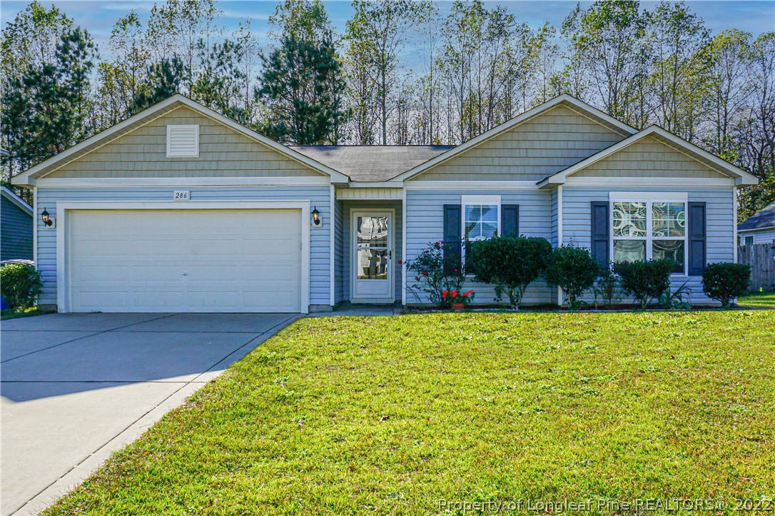 286 Cape Fear Road Raeford, NC 28376 - Photo 42 of 46 a front view of a house with garden