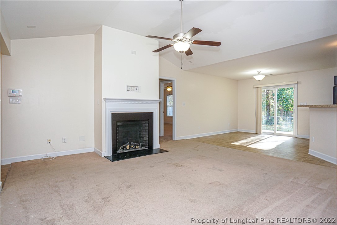 286 Cape Fear Road Raeford, NC 28376 - Photo 5 of 46 a view of an empty room with a fireplace and a window
