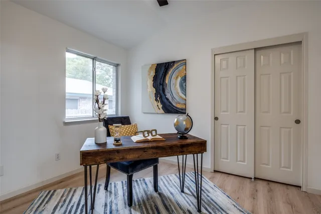 a view of a workspace with furniture and wooden floor