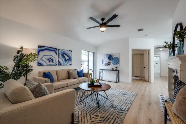 a living room with furniture and a wooden floor
