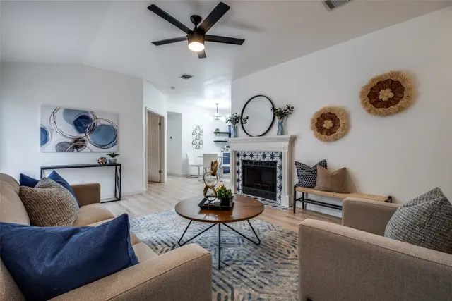 a living room with furniture a clock and a fireplace