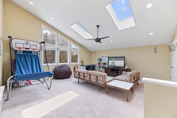 a living room with furniture a flat screen tv and a large window