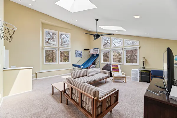 a view of play room with furniture and wooden floor