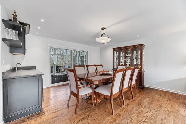 a view of a a dining room with furniture window and wooden floor