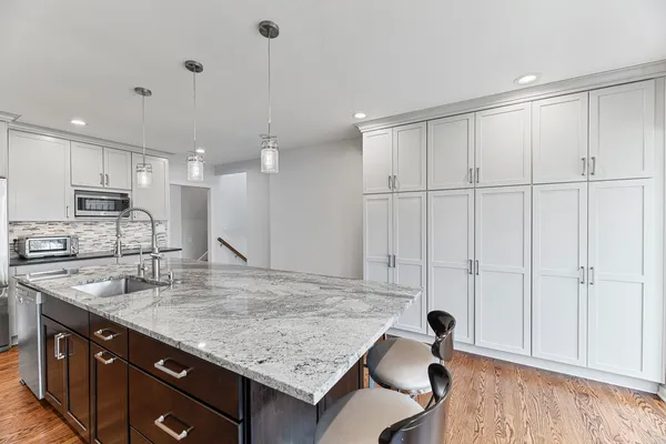 a large kitchen with a table and chairs