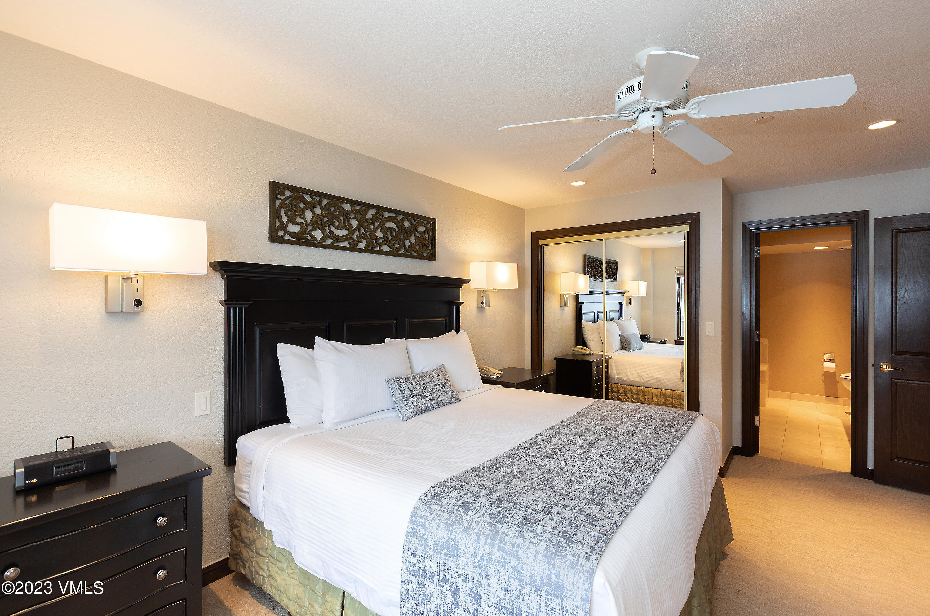 210 Offerson Road, Unit 207 WEEK 51 & 52 Beaver Creek, CO 81620 - Photo 9 of 26 a bedroom with a large bed and a chandelier